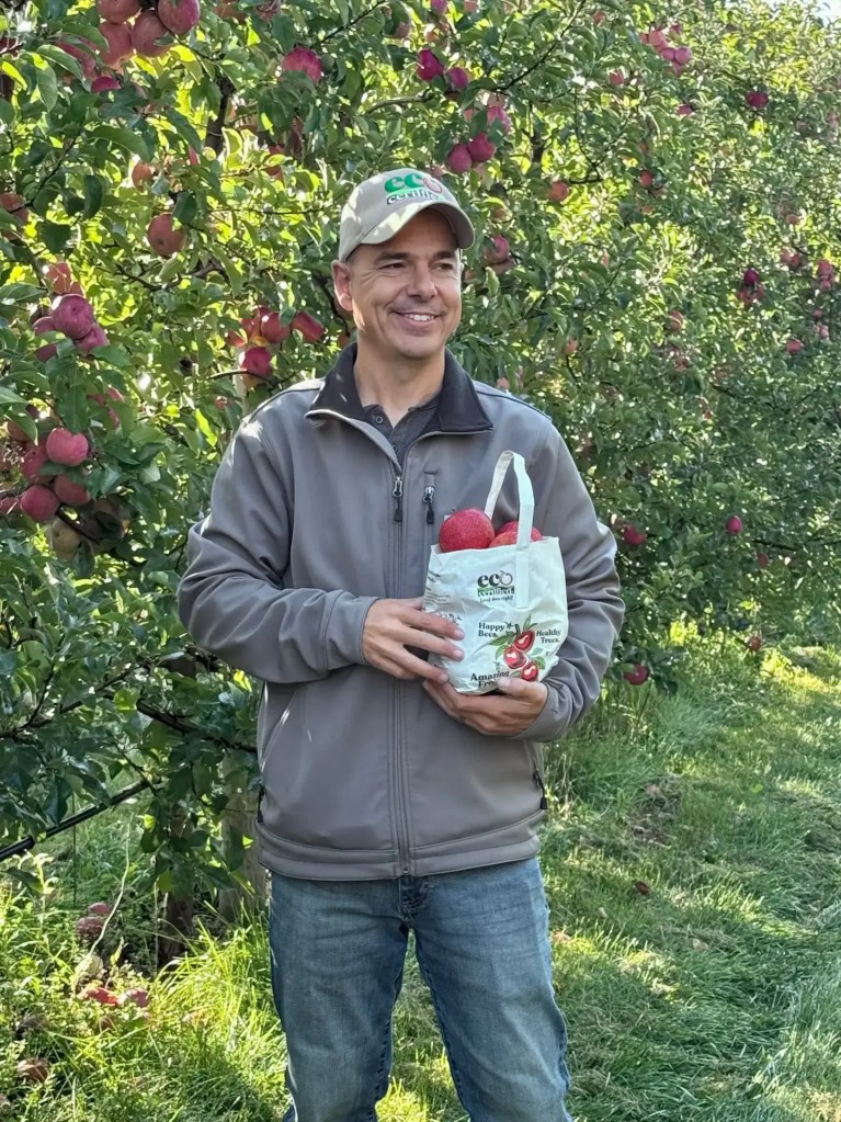 Michael Swindeman holding a bag of EcoCertified Apples