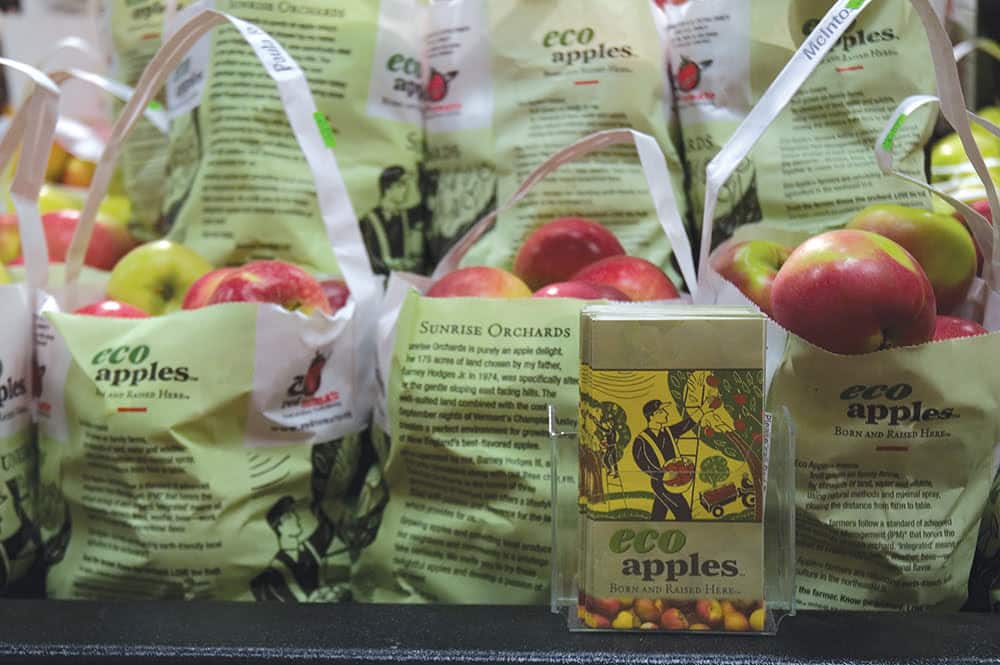 Russo's art on printed point of sale materials on display in a store's produce department.